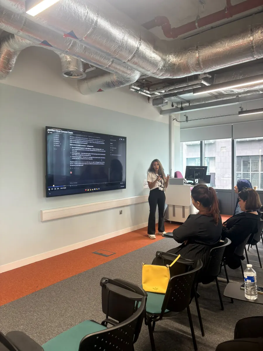 Zara presenting a live Claude Cowork demo to a seated audience